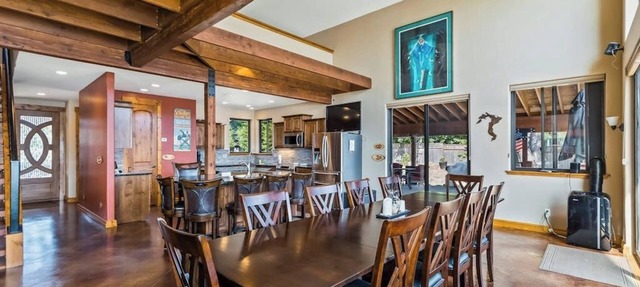 Custom riverfront home with private dock, game room, hot tub & heated floors in Laclede