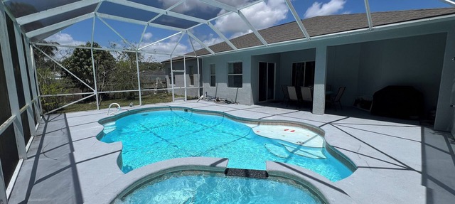 Modern and spacious getaway with a pool and grill in Cocoa