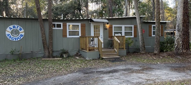 Step into this cozy 2-bedroom cabin nestled in the tranquil woods. The main living area offers comfy seating, including a pull-out futon for additional sleeping space. An efficiency kitchen awaits your culinary adventures, equipped with essentials fo in Inglis