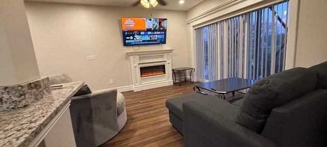 Private one-bedroom suite with king bed, walk-in closet, and ensuite bath featuring double vanity and safety grab bars. Enjoy serene pond views from your patio, full kitchen, and dedicated workspace for a comfortable stay. in Caseyville
